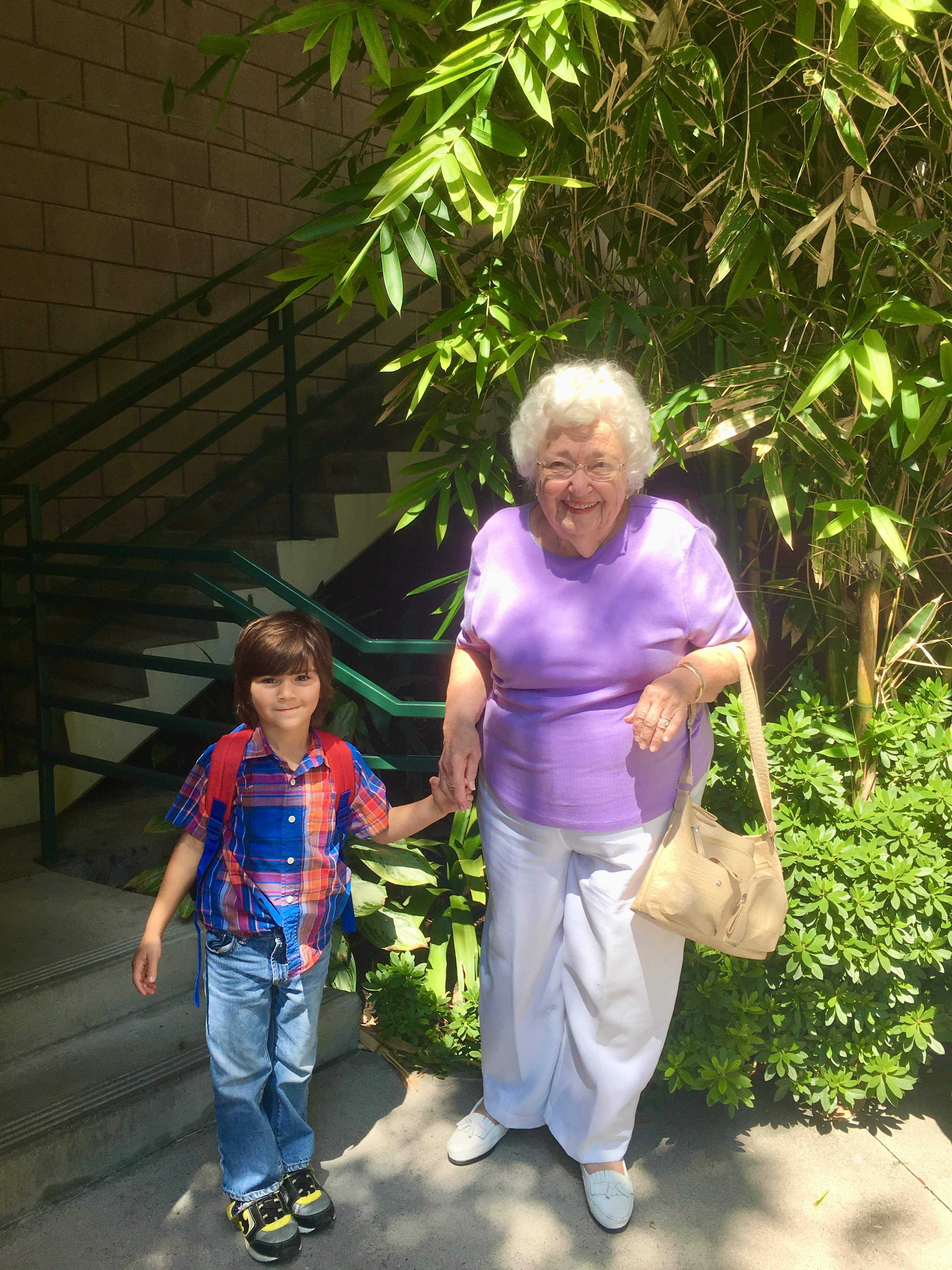 Grandmother walking with grandchild outdoors
